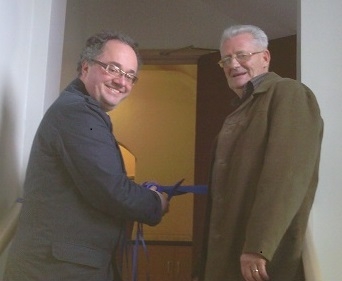 Rupert Matthews cuts the ribbon with Roger Willers